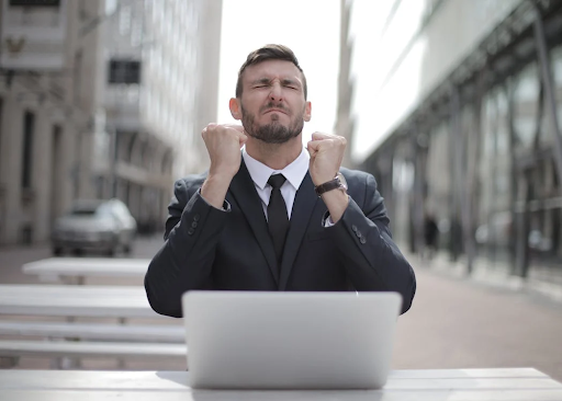 man using laptop in street