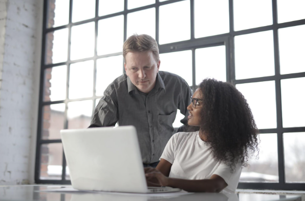 man and woman looking at laptop