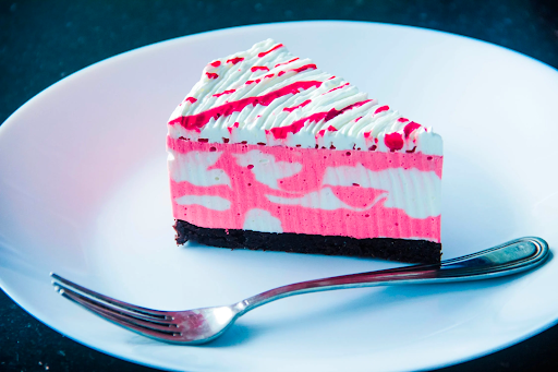 slice of white and pink cake