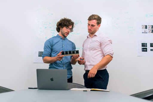 two men working on a laptop