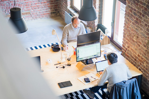 two men working at computers