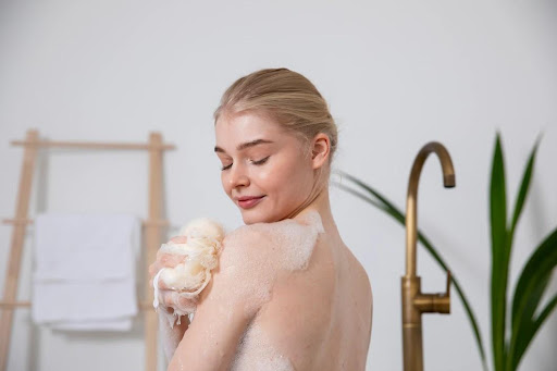 woman washing with shower sponge