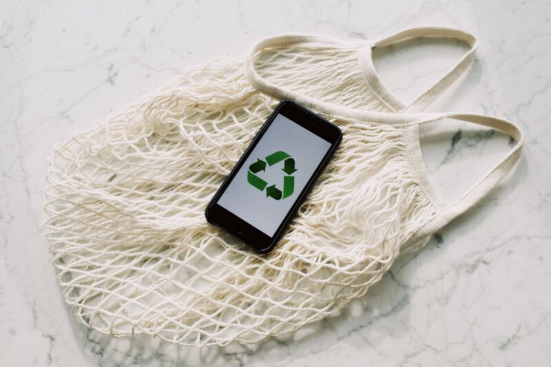 mesh bag and mobile phone with recycling symbol
