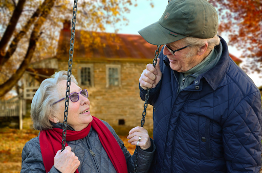 elderly couple woman on swing