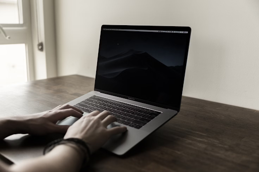 open laptop on dark wood table