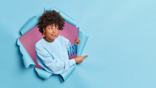 Lady sticking her head through blue background