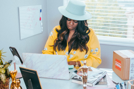 lady wearing hat working at computer