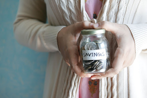 woman holding savings jar in her hands