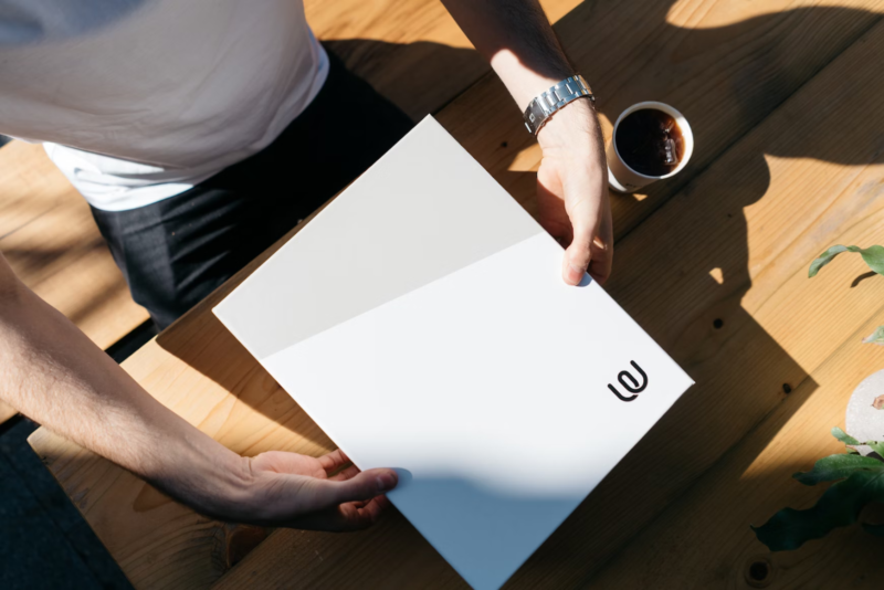 man holding branded paper