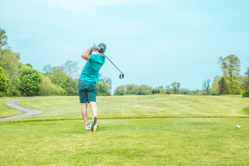 man swinging golf club
