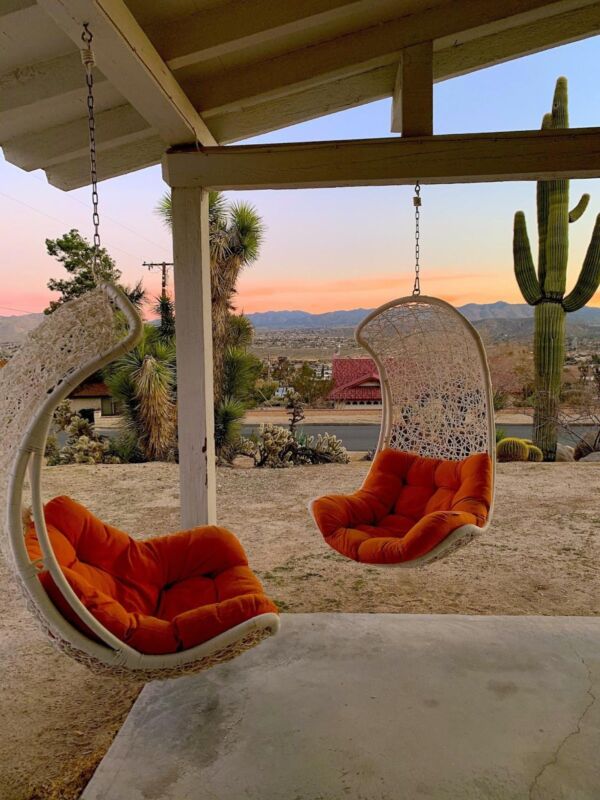 two orange and white swing chairs