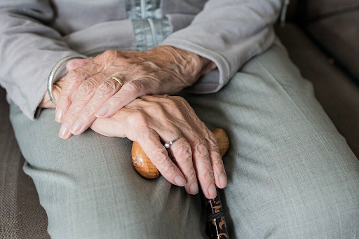 elderly lady's hands holding cane