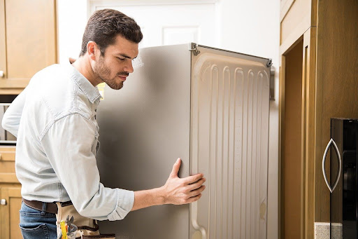 man moving fridge