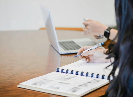 person writing in notebook