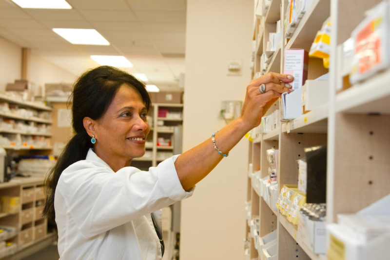 pharmacist reaching for pills