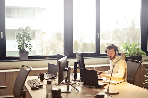 man at computer wearing headphones