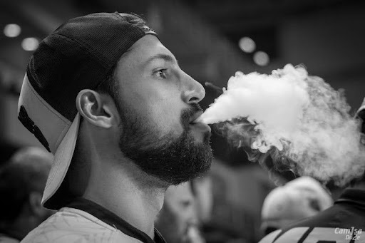 man blowing smoke