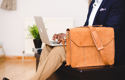 person with laptop and briefcase