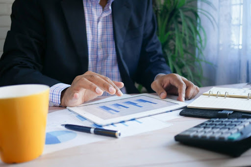 man looking at chart on tablet